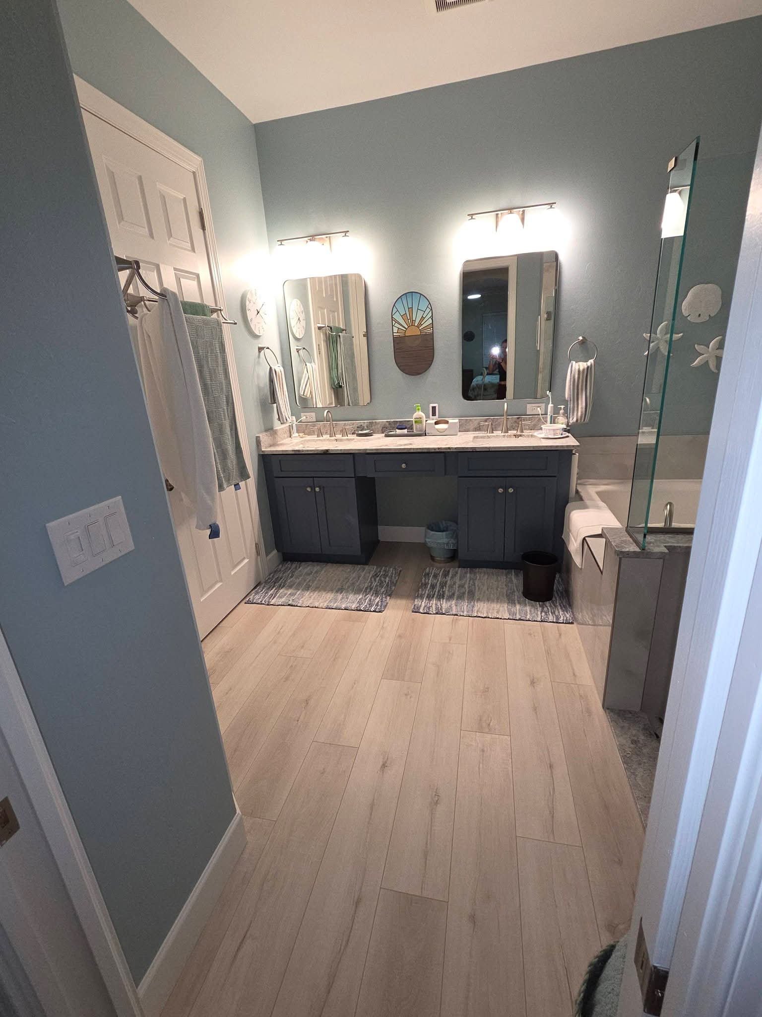 Coastal blue bathroom with navy double vanity