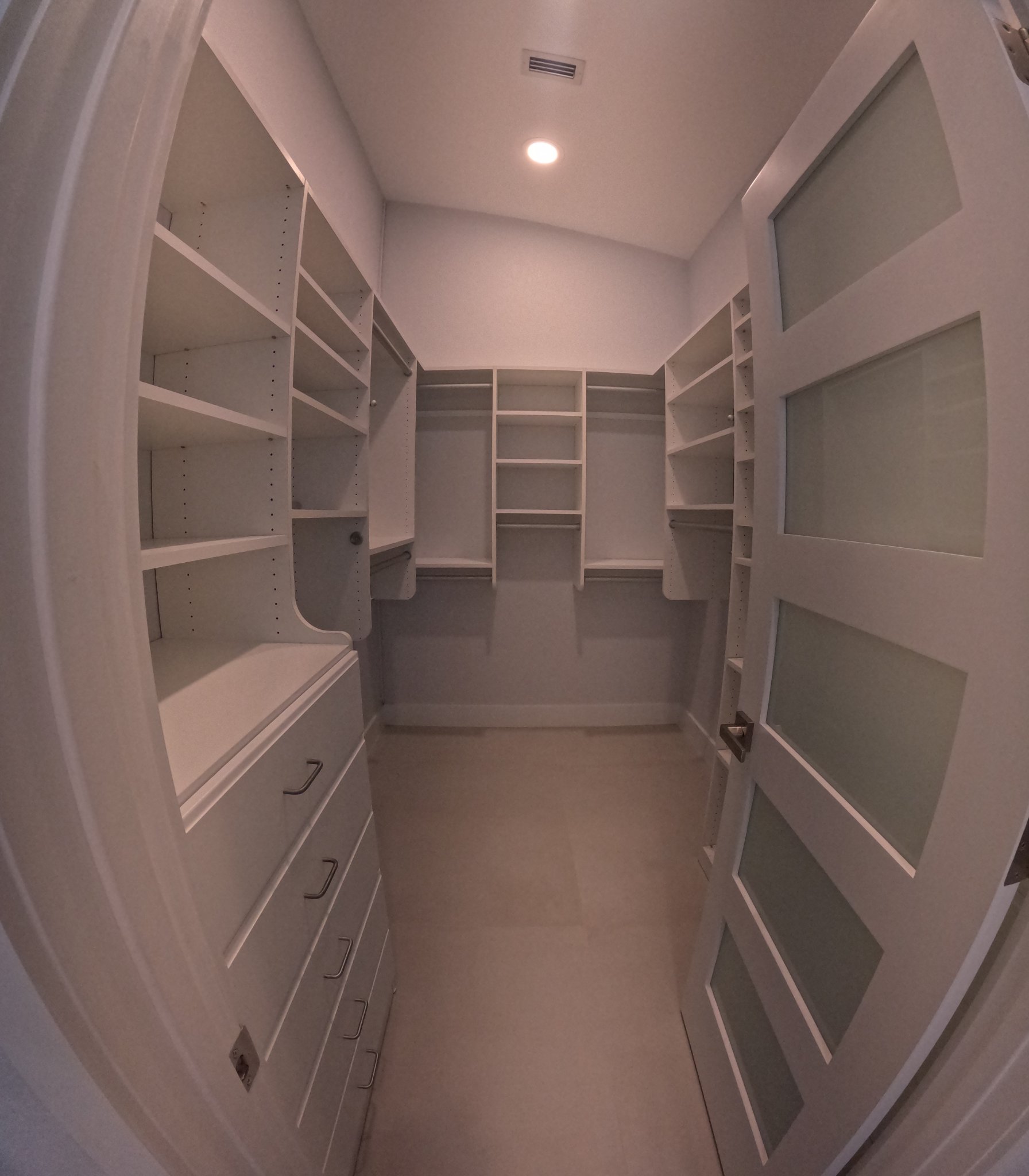 Organized walk-in closet with spotless shelving