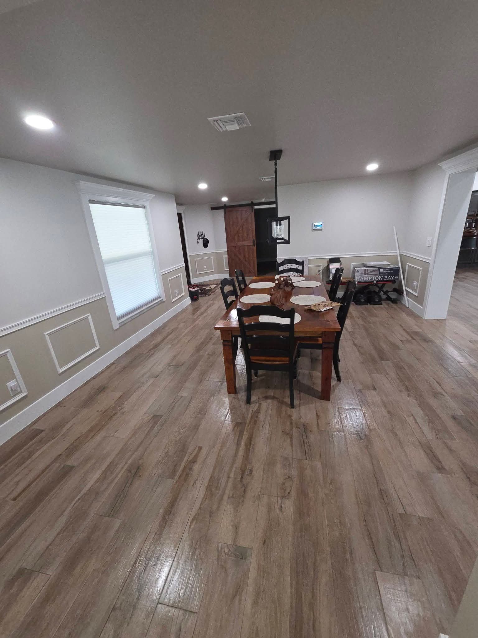 Dining room with farmhouse table and gleaming wood floors