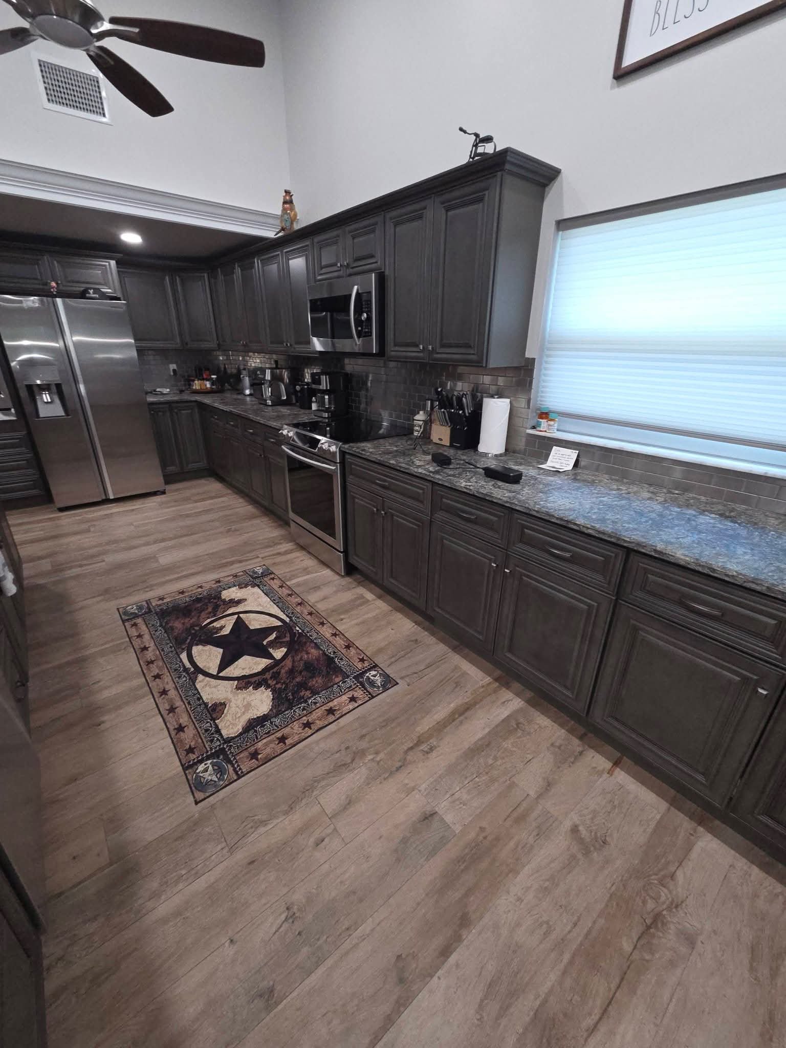 Dark cabinet kitchen from the refrigerator side, floors gleaming