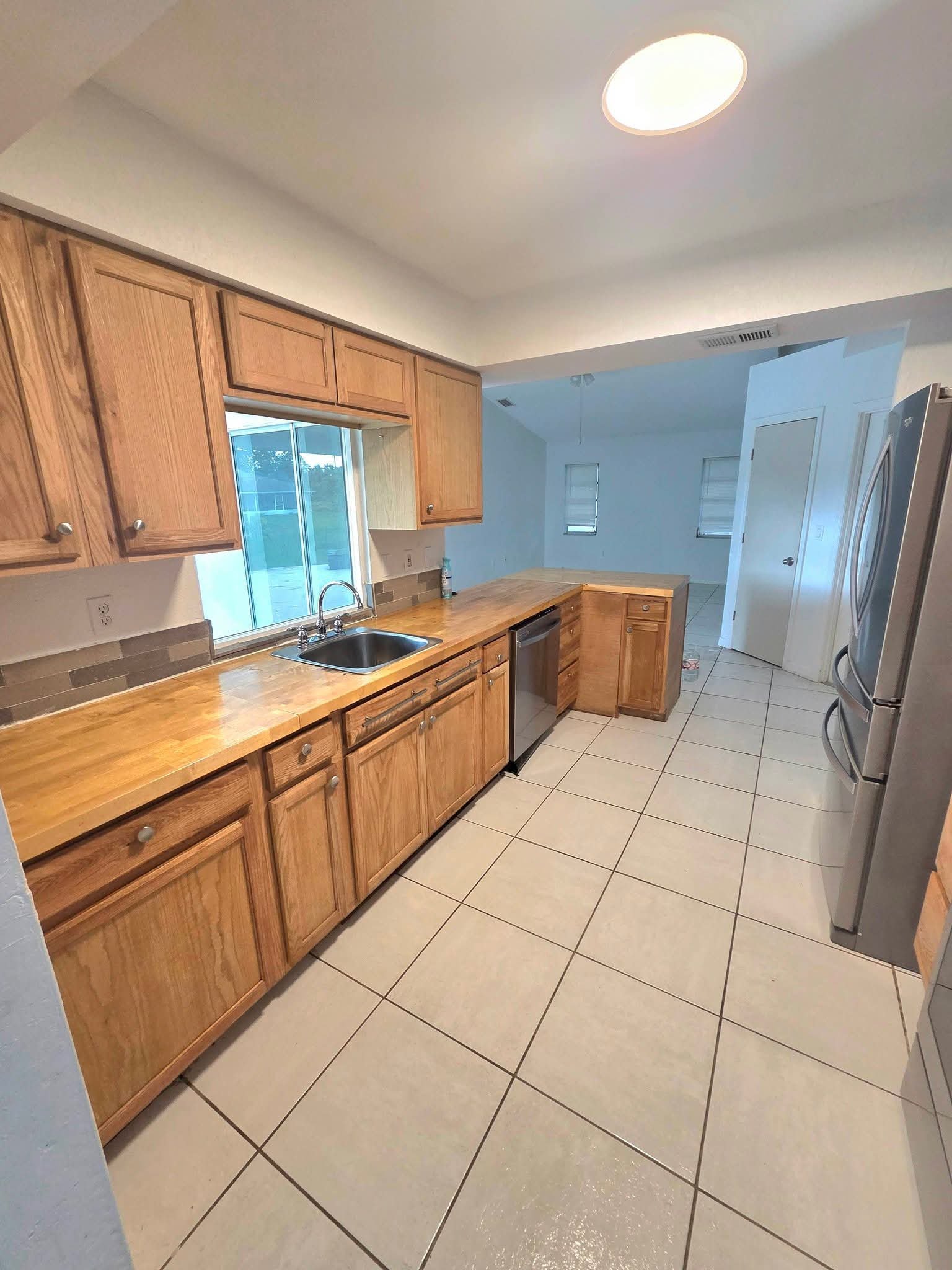 Warm wood kitchen with butcher block counters after cleaning