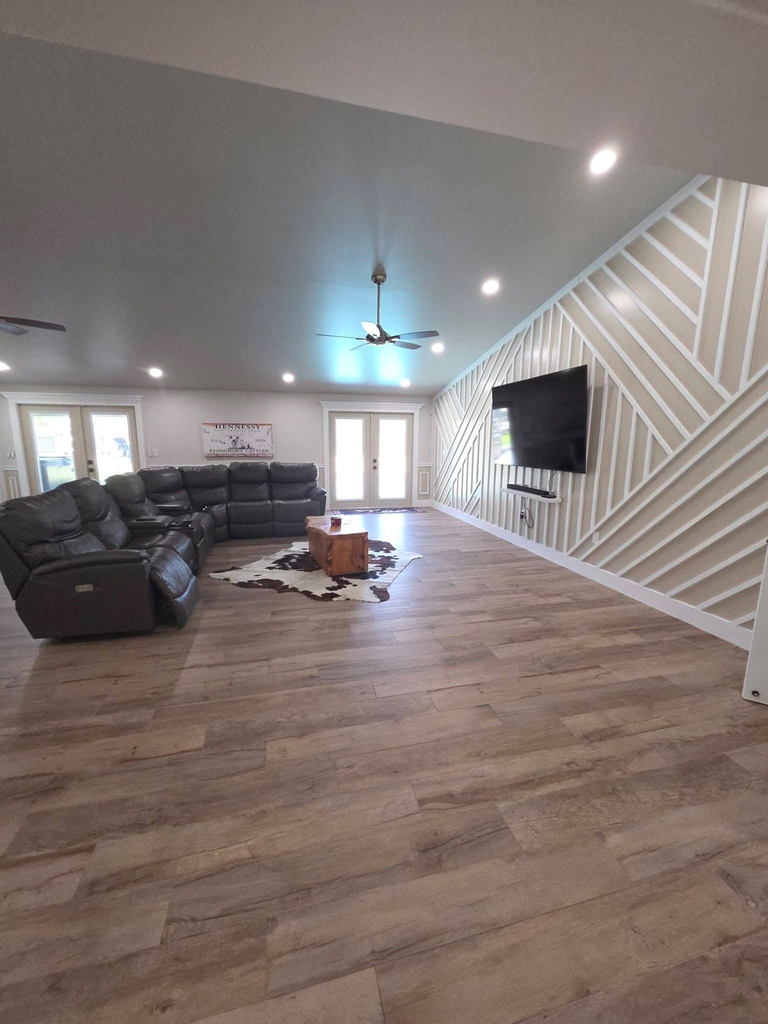 Spacious living room with leather seating and polished floors